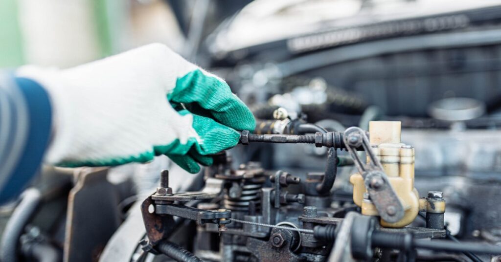 Mechanic repairing power steering pump in engine