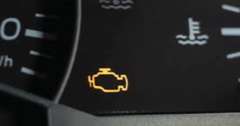 Can I put power steering fluid in a hot car Car dashboard displaying an illuminated engine light