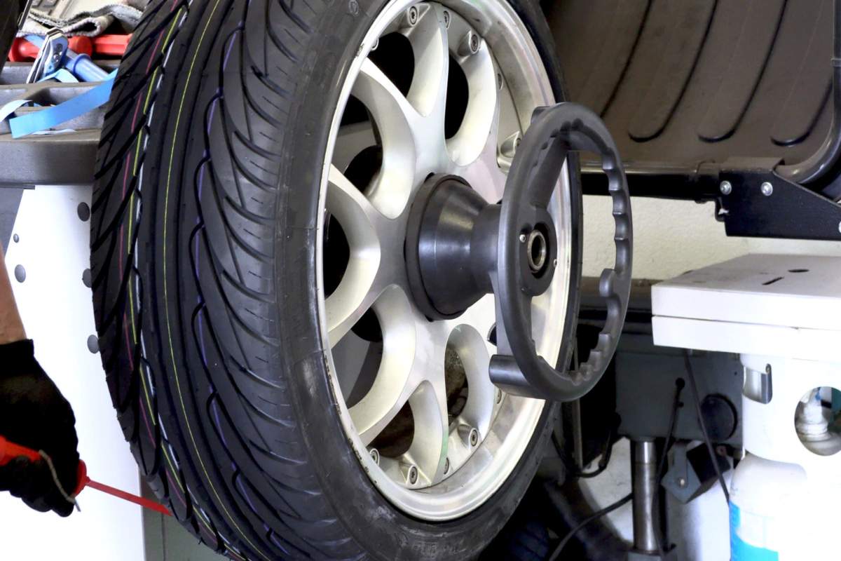 Car wheel showing uneven tire wear due to improper wheel balancing.