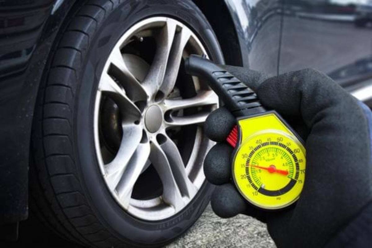 Car tyre pressure gauge showing low and high tyre readings