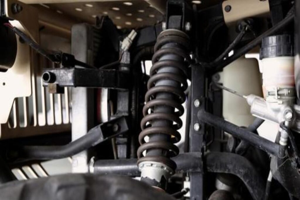 Close-up of car suspension components showing loose or worn parts.