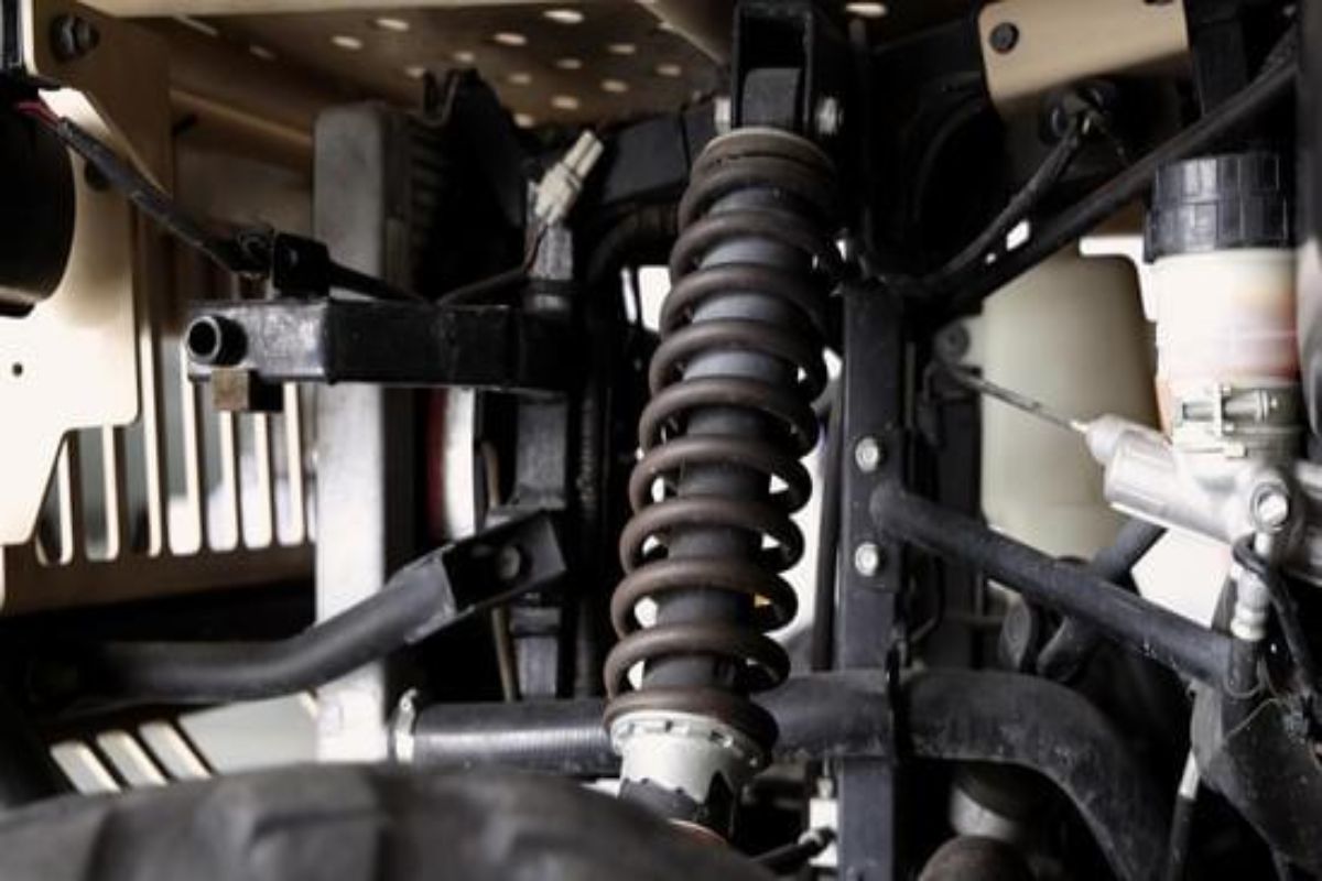 What causes brake pedal vibration Close-up of car suspension components showing loose or worn parts.